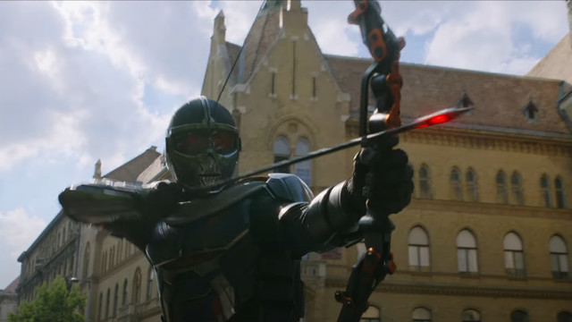 Taskmaster from the Black Widow movie shooting an explosive arrow out of a vehicle
