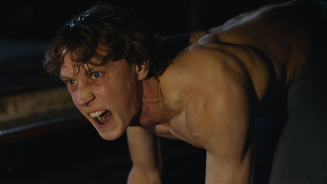 George MacKay, on all fours and snarling, in Wolf