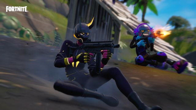 Two Fortnite characters slide down an incline while firing their weapons